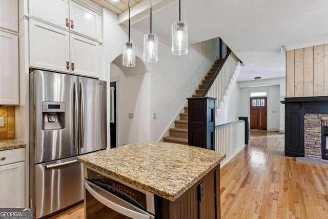 kitchen featuring stainless steel refrigerator with ice dispenser and white cabinets