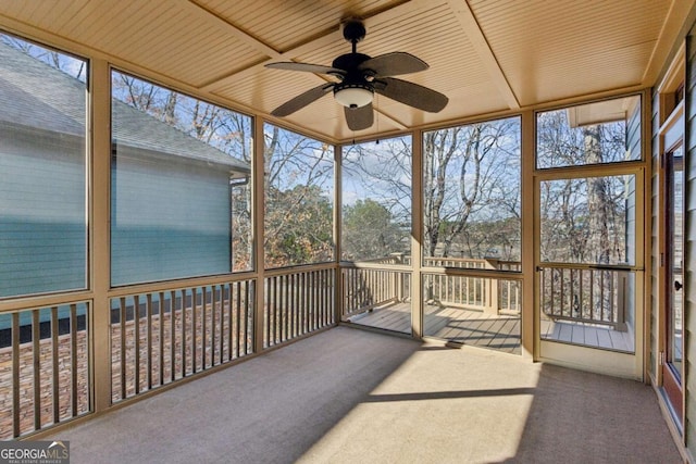 sunroom featuring wood ceiling and ceiling fan