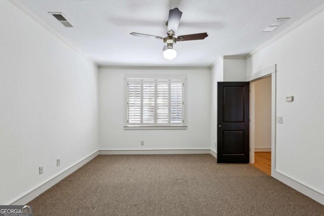 unfurnished room with crown molding, carpet floors, a textured ceiling, and ceiling fan