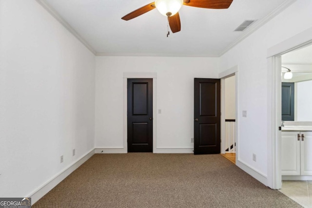 unfurnished bedroom featuring crown molding, ceiling fan, connected bathroom, and light carpet