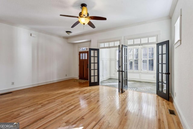 unfurnished room with ceiling fan, ornamental molding, and light hardwood / wood-style flooring