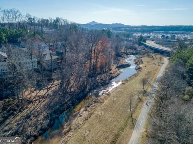 birds eye view of property featuring a water and mountain view