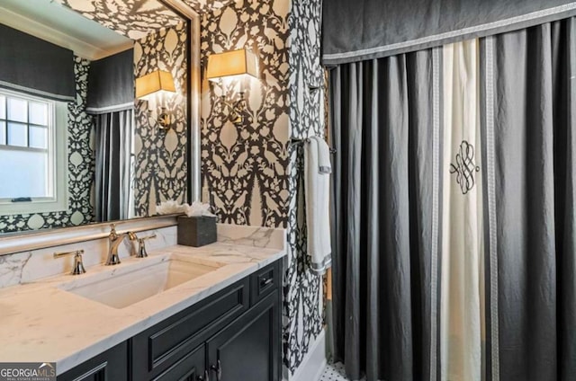 bathroom with vanity and ornamental molding