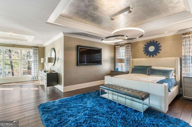 bedroom with multiple windows, a tray ceiling, crown molding, and dark hardwood / wood-style floors