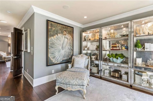 living area featuring crown molding and dark hardwood / wood-style floors