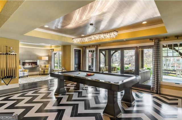 game room featuring crown molding, a large fireplace, pool table, and a tray ceiling