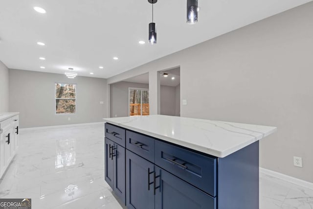 kitchen with hanging light fixtures, a kitchen island, light stone countertops, white cabinets, and blue cabinets