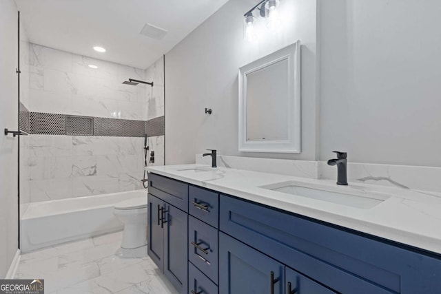 full bathroom with vanity, tiled shower / bath combo, and toilet