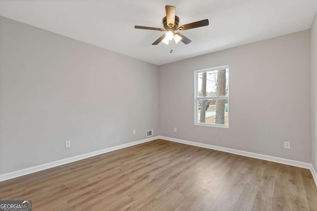 empty room featuring ceiling fan and light wood-type flooring