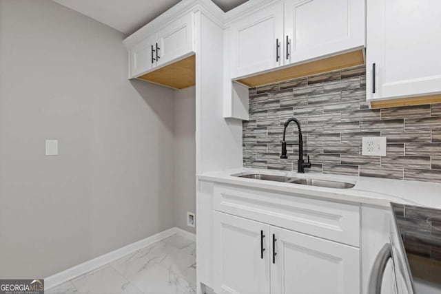 kitchen with sink, stainless steel electric range, white cabinetry, tasteful backsplash, and light stone counters