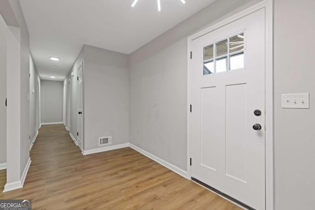 foyer entrance with light hardwood / wood-style floors