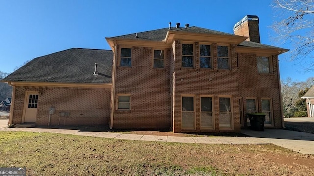 rear view of property with a lawn and a patio