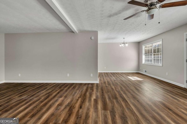 empty room with dark hardwood / wood-style floors, ceiling fan with notable chandelier, beam ceiling, and a textured ceiling