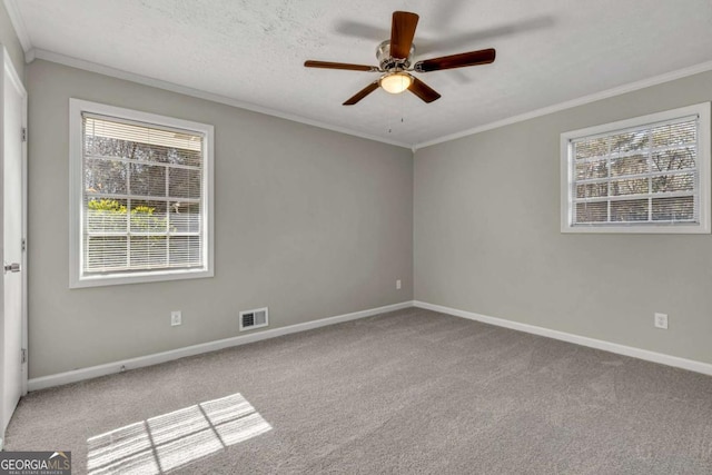 empty room featuring crown molding, ceiling fan, light carpet, and a textured ceiling