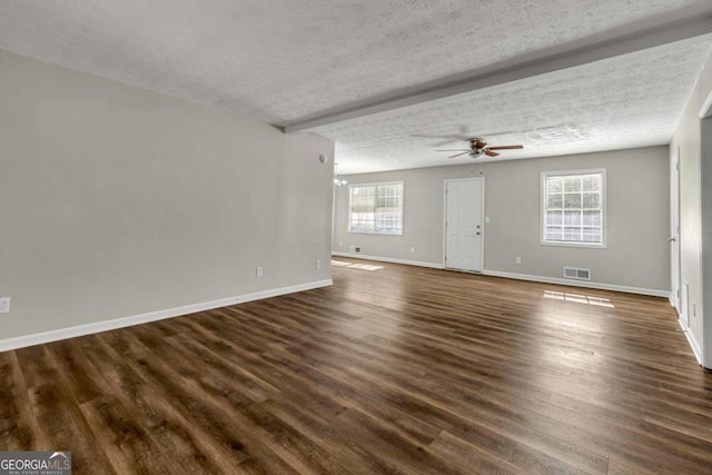 unfurnished living room with ceiling fan, dark wood-type flooring, and a textured ceiling