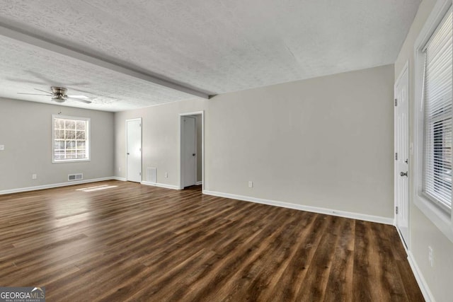 spare room with ceiling fan, dark hardwood / wood-style floors, and a textured ceiling