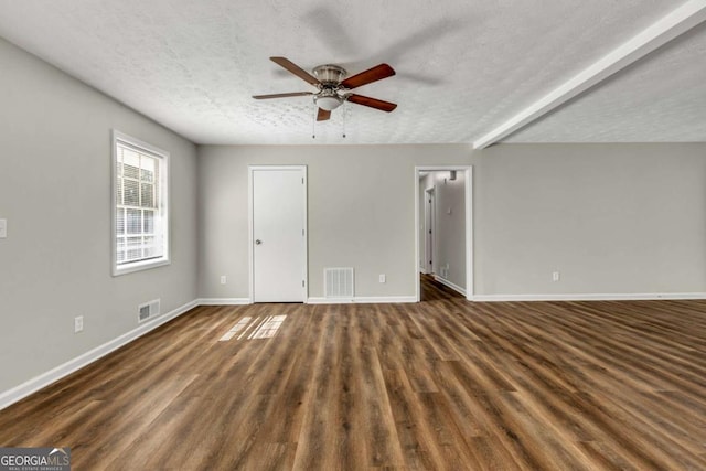 unfurnished room with ceiling fan, dark hardwood / wood-style flooring, and a textured ceiling