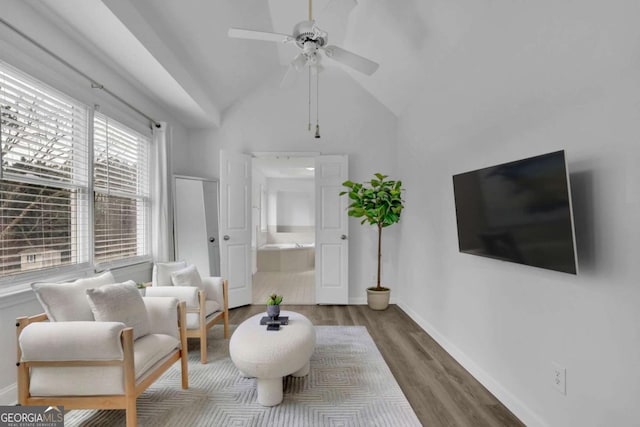 sitting room featuring vaulted ceiling, dark hardwood / wood-style floors, and ceiling fan