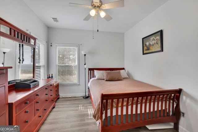 bedroom with ceiling fan and light hardwood / wood-style floors