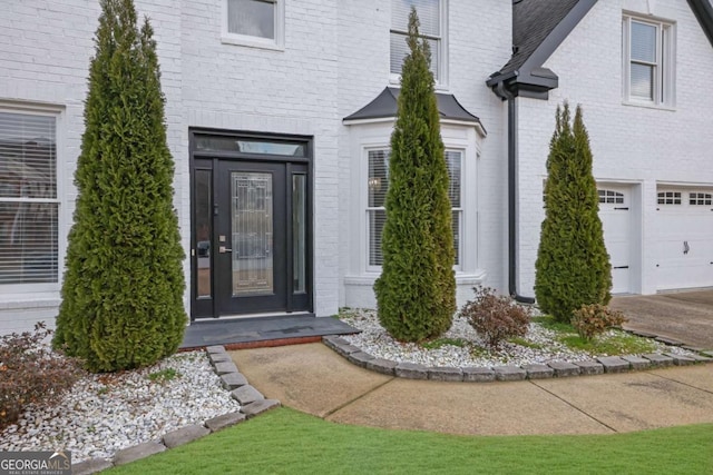 view of exterior entry with a garage