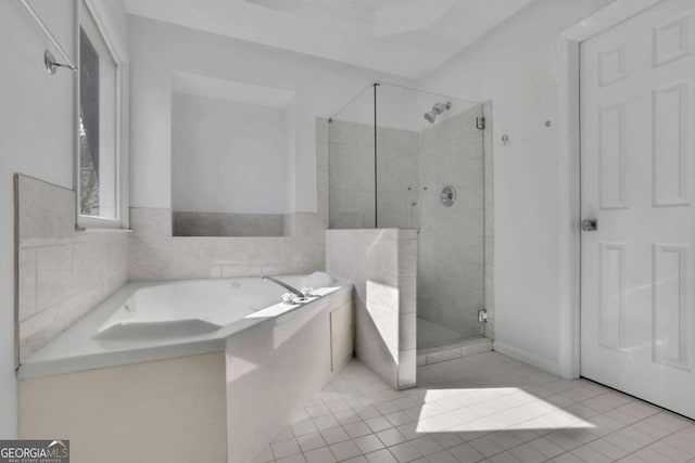 bathroom with tile patterned floors and separate shower and tub