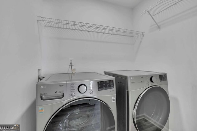 clothes washing area featuring washing machine and dryer