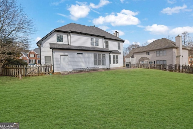 back of house featuring a yard