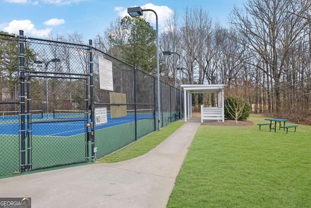 view of sport court with a yard and tennis court