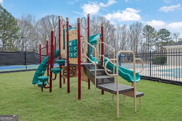 view of play area featuring a fenced in pool and a lawn