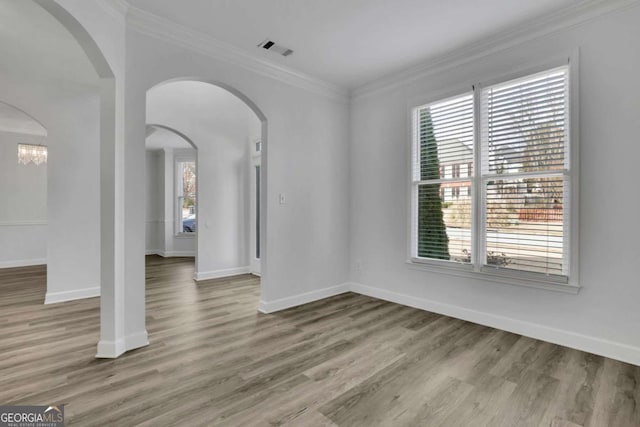 unfurnished room featuring hardwood / wood-style flooring and crown molding