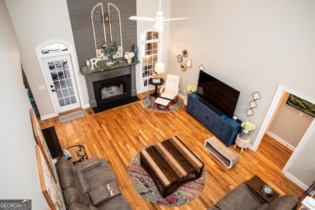 living room featuring wood-type flooring and a high ceiling