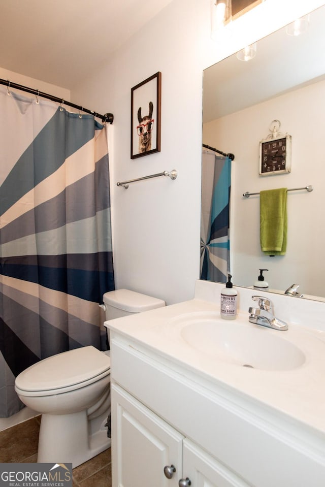 bathroom featuring tile patterned floors, toilet, and vanity