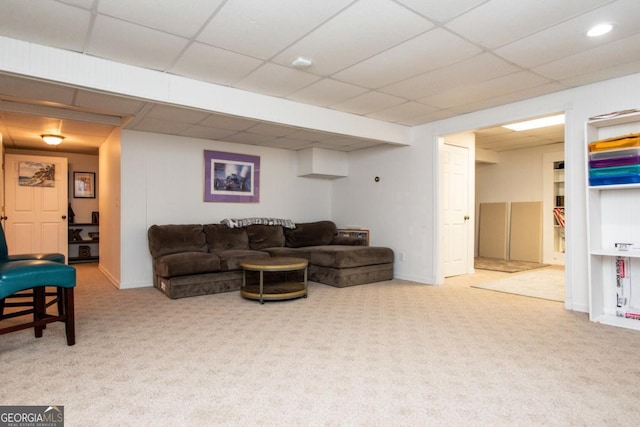 carpeted living room with a drop ceiling