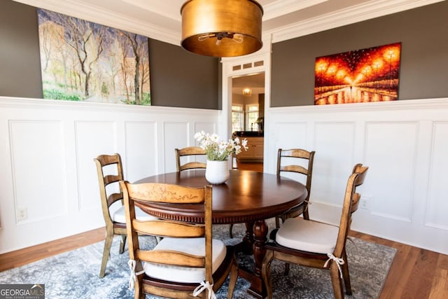 dining room featuring hardwood / wood-style flooring and ornamental molding