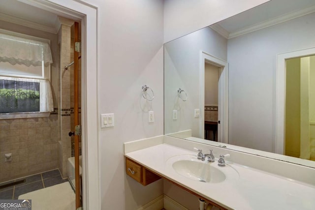 bathroom with sink, crown molding, and tile patterned floors