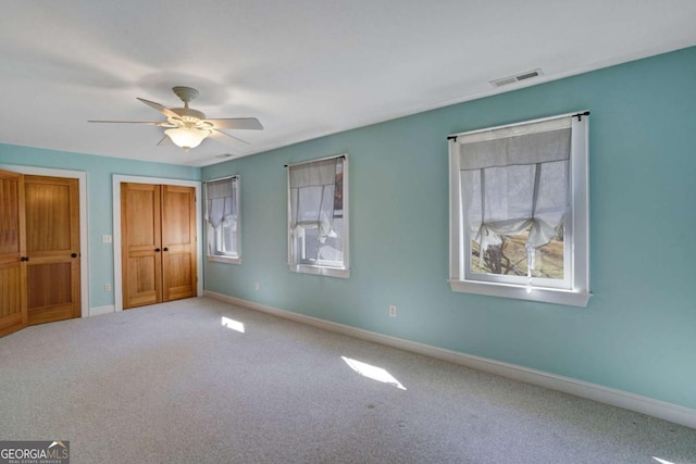 unfurnished bedroom featuring carpet floors and ceiling fan