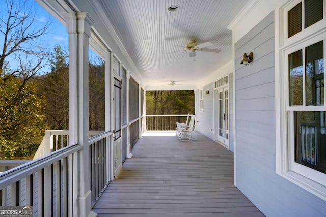 deck with ceiling fan and a porch