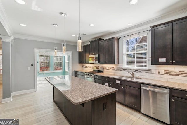 kitchen featuring sink, hanging light fixtures, dark brown cabinets, stainless steel appliances, and a kitchen island