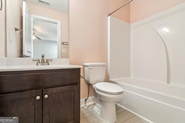 full bathroom with washtub / shower combination, vanity, and toilet