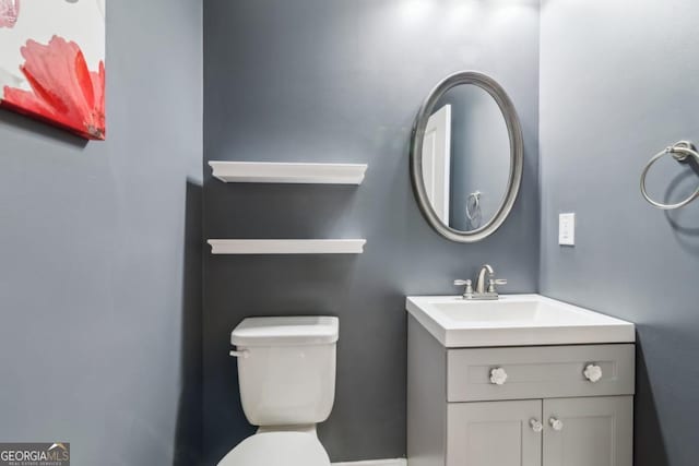 bathroom featuring vanity and toilet