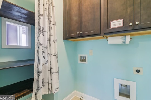 laundry area with cabinets, hookup for a washing machine, and hookup for an electric dryer