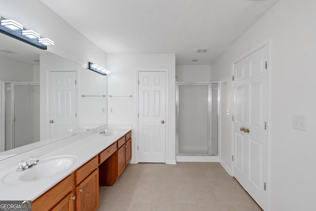 bathroom with vanity and a shower with shower door