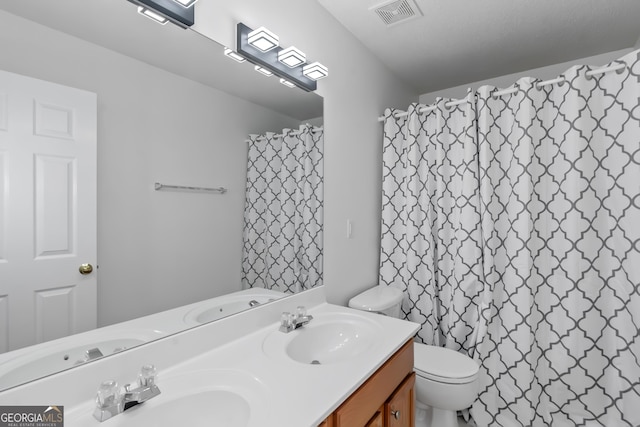 bathroom featuring vanity, toilet, and a shower with shower curtain