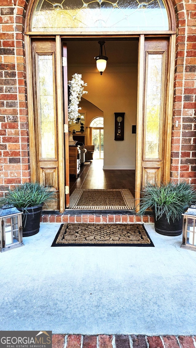 doorway to property with brick siding