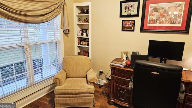 home office featuring built in shelves and wood finished floors