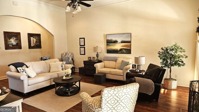 living area with ceiling fan, ornamental molding, dark wood-style flooring, and baseboards