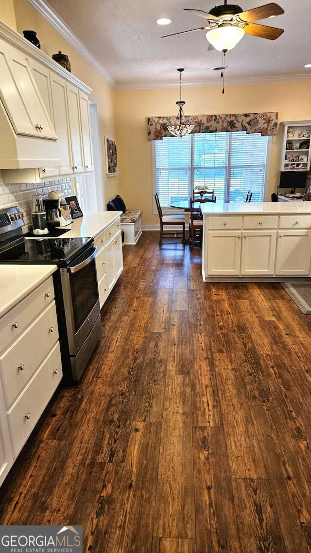 kitchen featuring stainless steel electric range, white cabinets, and crown molding