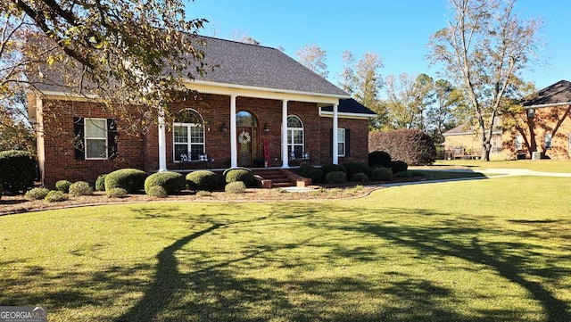 view of front of home with a front lawn and brick siding