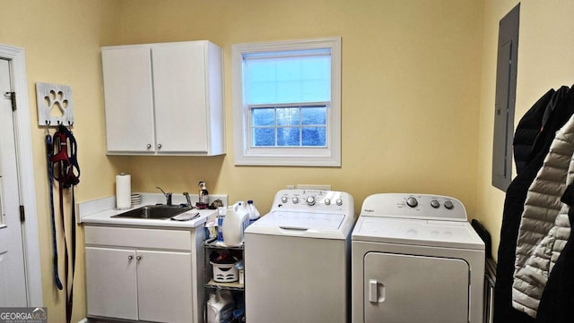 laundry room with separate washer and dryer, a sink, and cabinet space