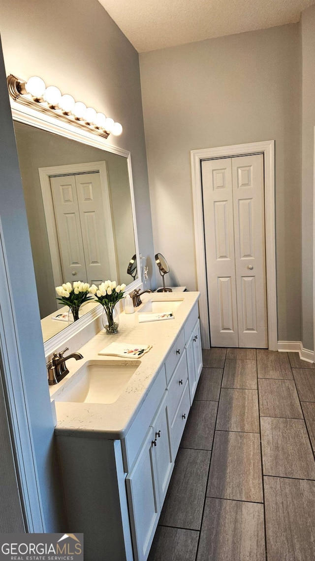 full bathroom featuring double vanity and a sink